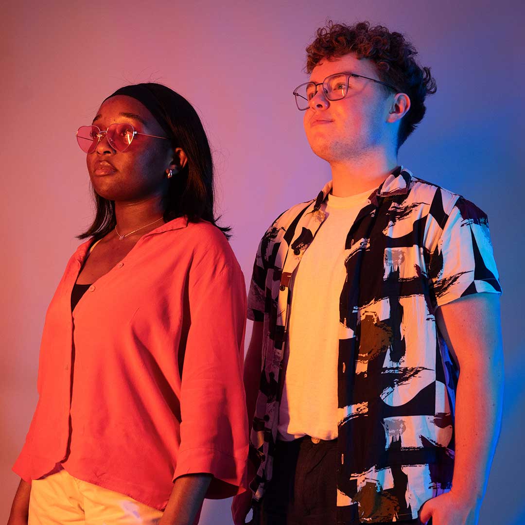 Two students looking off to the side of the camera looking serious