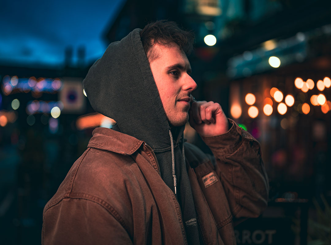 Side profile of a student wearing a hood