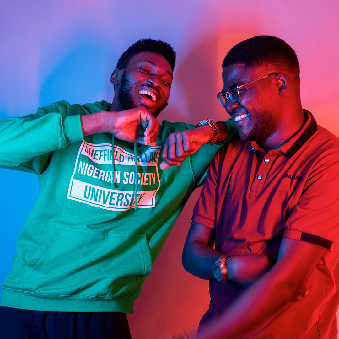 Two students laughing at the camera