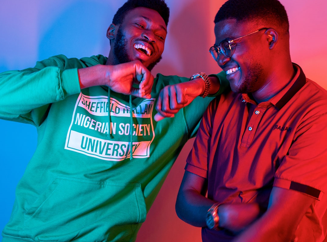 Two students laughing at the camera