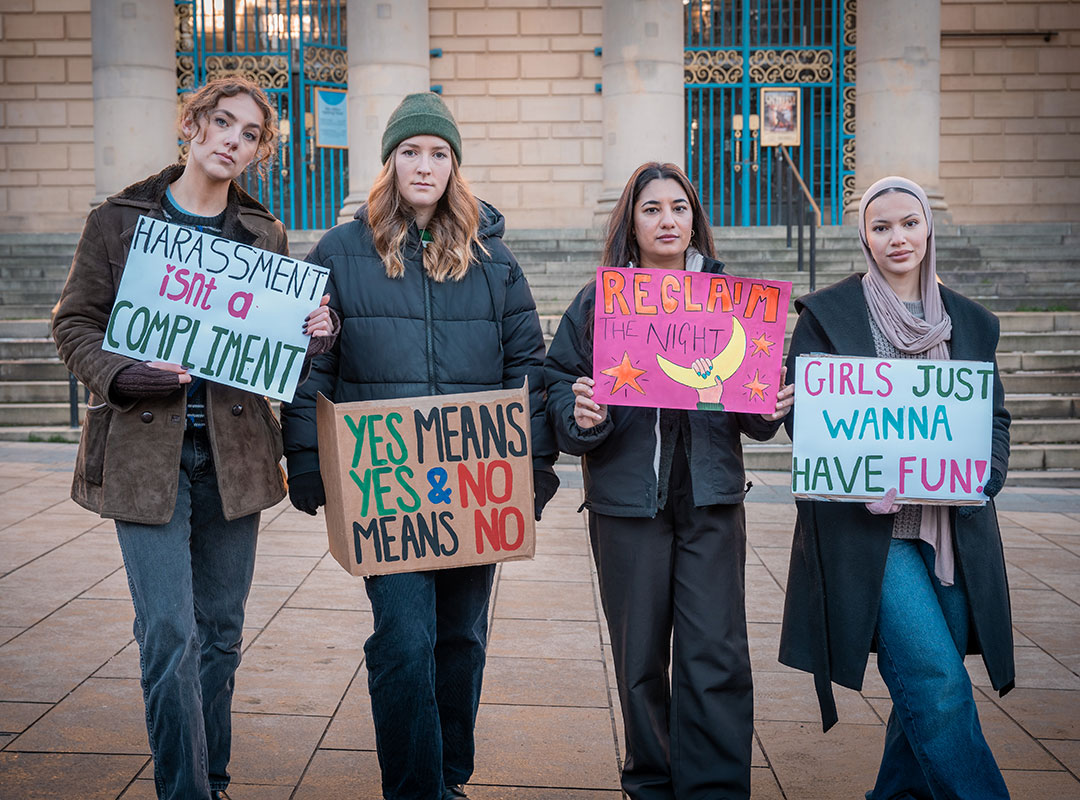 Four HSU Officers stood outside holding placards and looking serious.