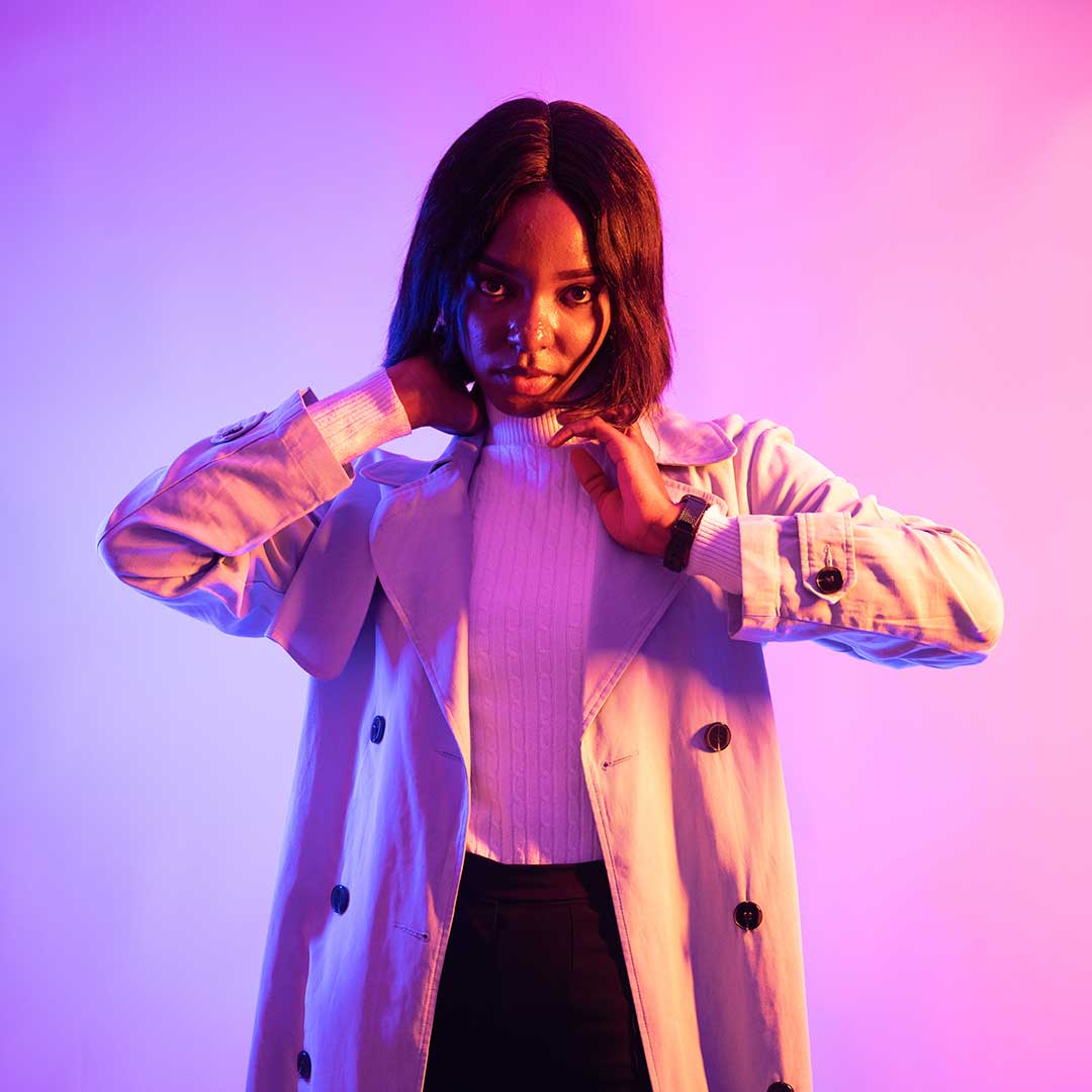 A student wearing a white turtleneck and a long white blazer