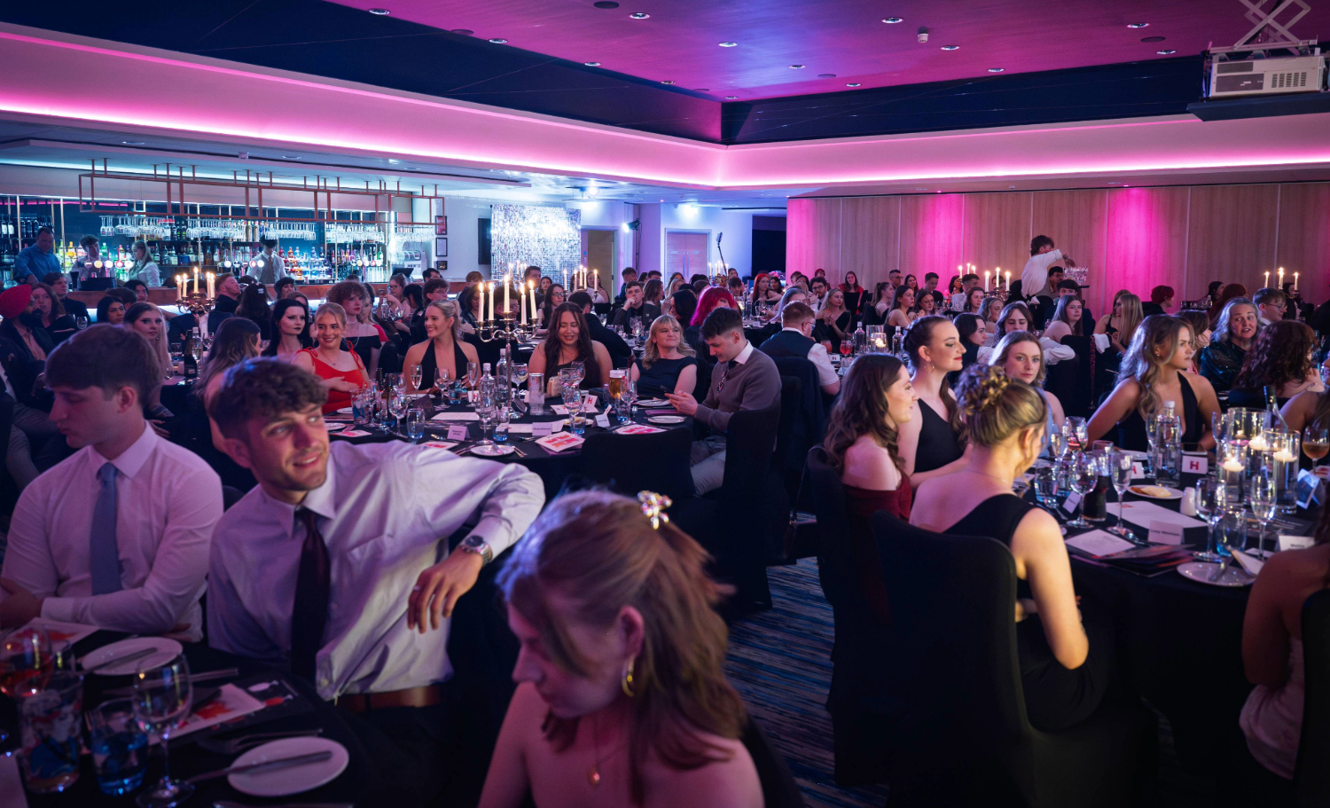 A student wearing a white turtleneck and a long white blazer
