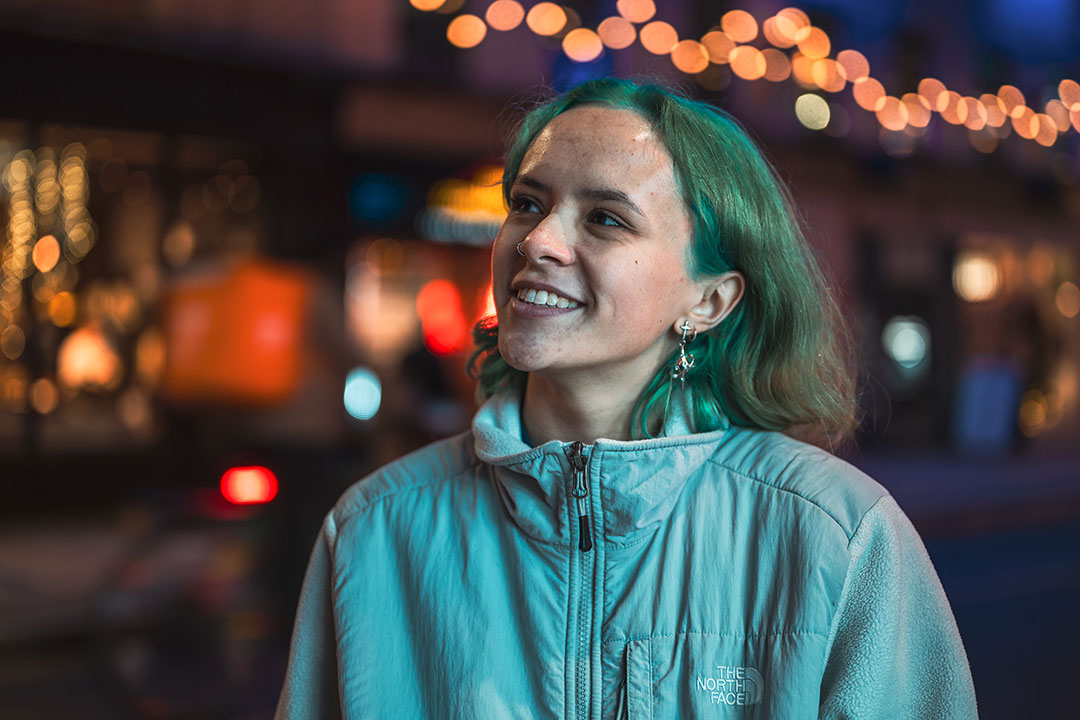 Student smiling and looking into the distance