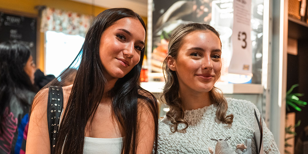 Two students smiling.